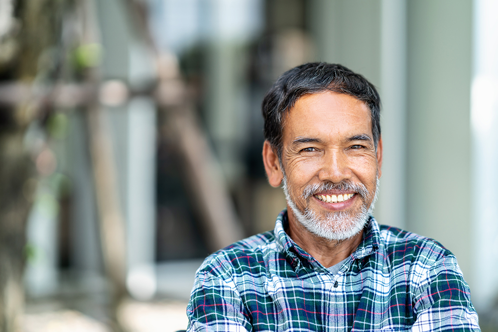 Portrait of happy mature man with white, grey stylish short beard