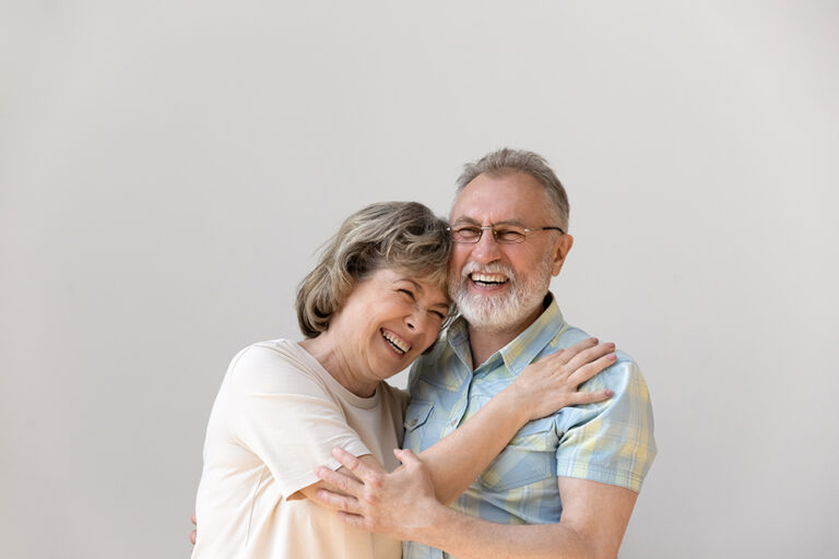 Sincere laughing bonding middle aged couple
