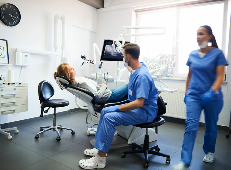 Dentist consulting with patient